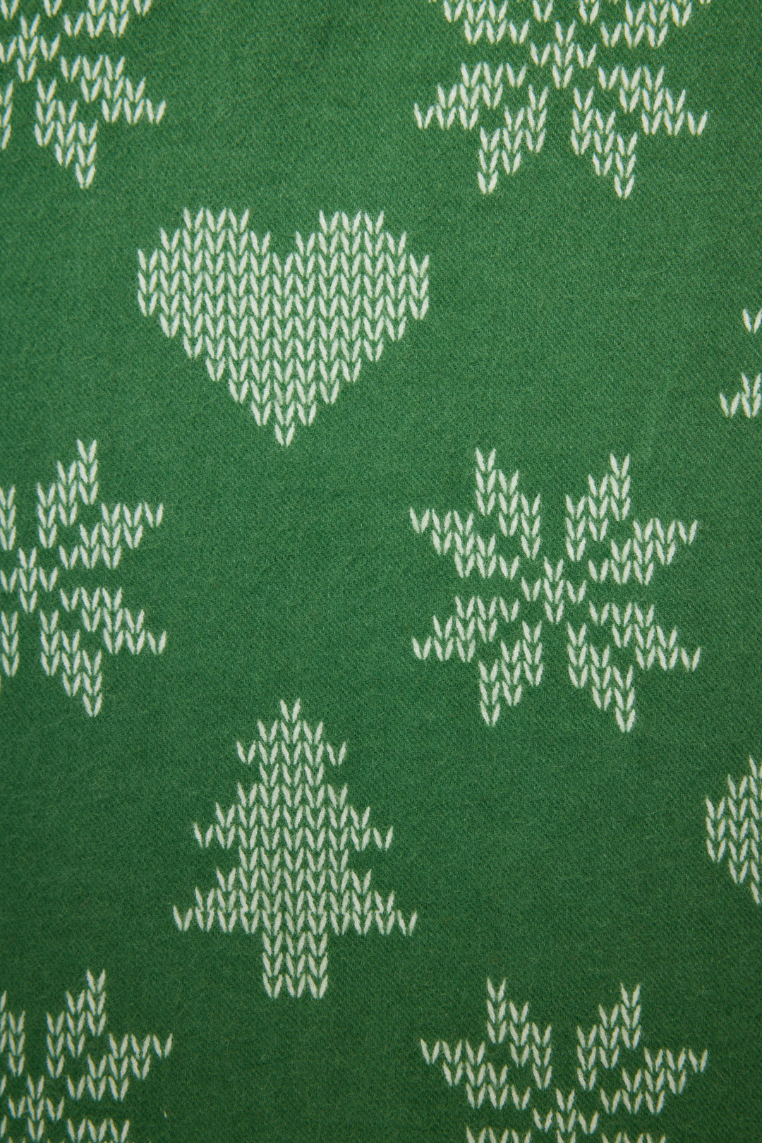 The 4-Piece Tree & Heart Print Flannel PJ Set by P.J. Salvage features green fabric with white heart, pine tree, and snowflake motifs in a festive winter design.