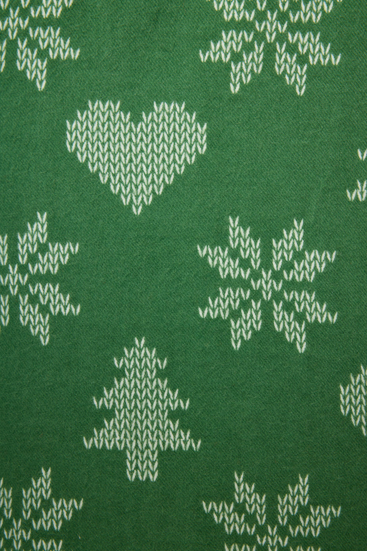 The 4-Piece Tree & Heart Print Flannel PJ Set by P.J. Salvage features green fabric with white heart, pine tree, and snowflake motifs in a festive winter design.