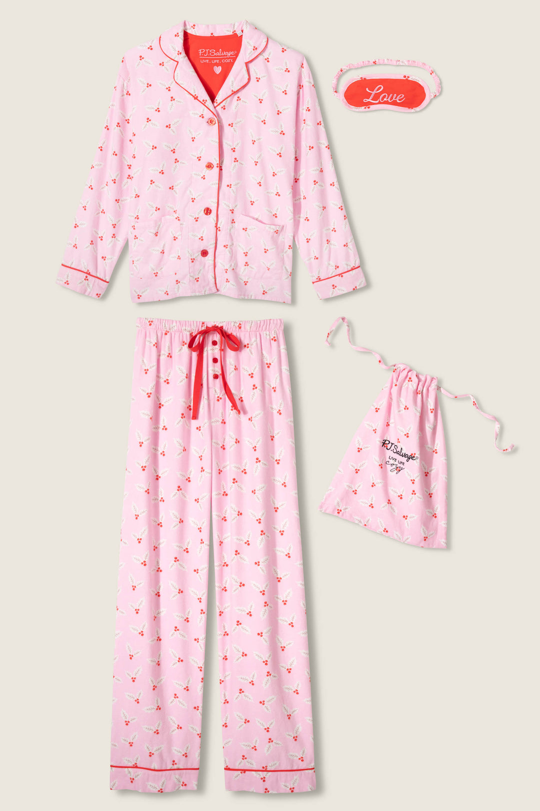 The P.J. Salvage 4-Piece Mistletoe Print Flannel PJ Set includes a button-up long-sleeve top, matching pants with red drawstring, a "Love" sleep mask, and a drawstring bag, all with a red and white heart pattern.