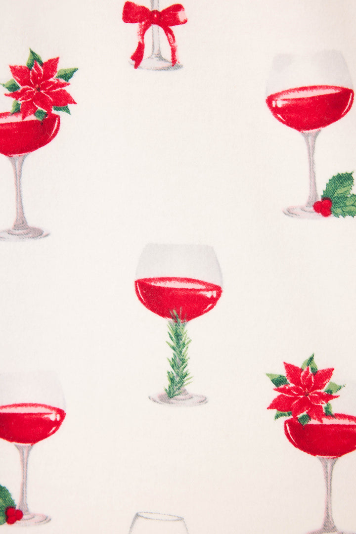 The BEARS PJ SET FLANNELS by P.J. Salvage features a white background with red wine glasses, each adorned with holiday touches like poinsettias, holly, a red bow, and greenery.