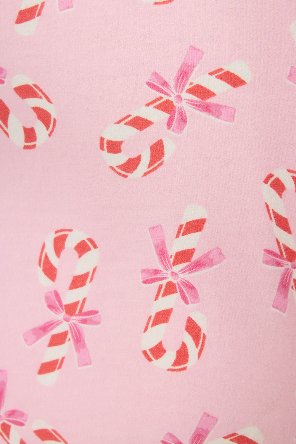 The 3-Piece Candy Cane Print Flannel PJ Set by P.J. Salvage features a pink background with a repeating pattern of red and white candy canes, each tied with a pink ribbon.