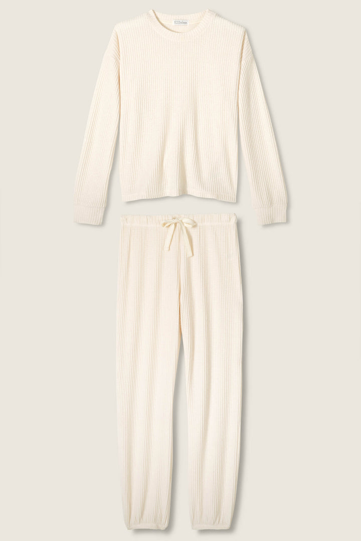 The SOLID PJ SET FIRESIDE SPARKLE SET by P.J. Salvage features a cream-colored, ribbed knit loungewear set with a long-sleeved top and drawstring pants with elastic cuffs, displayed flat on a neutral background.
