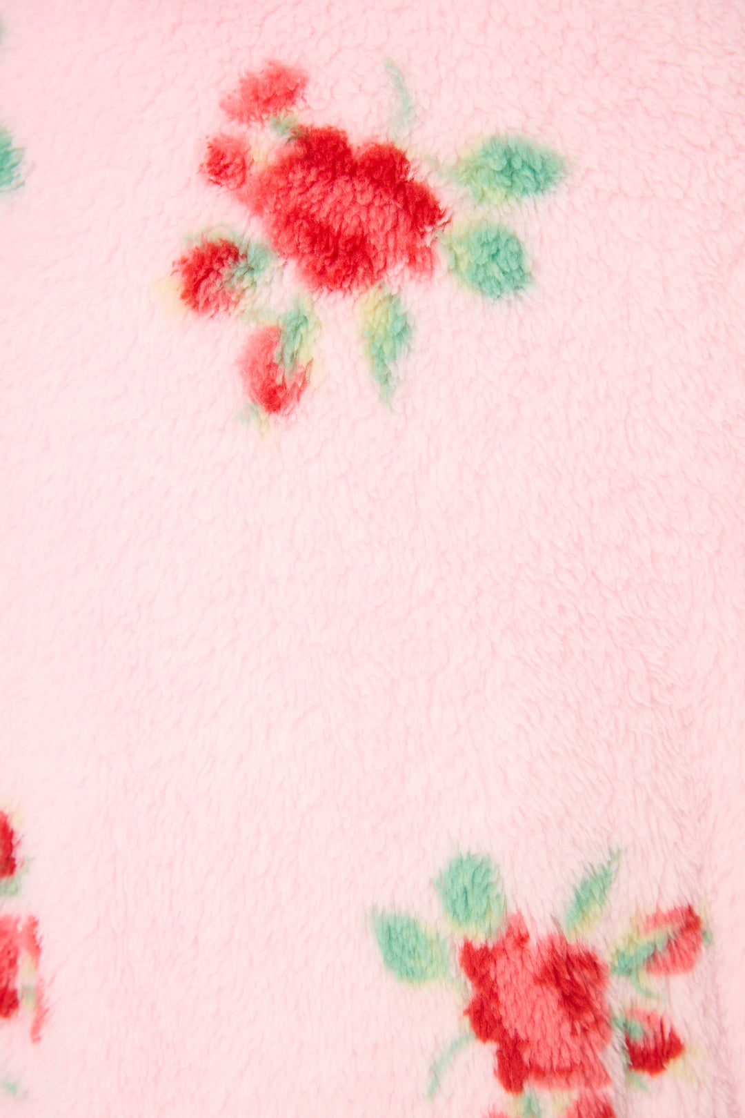 Close-up of the Rose Print Plush Robe by P.J. Salvage, featuring soft pink fleece with red and green rose designs and a cozy, fuzzy texture.