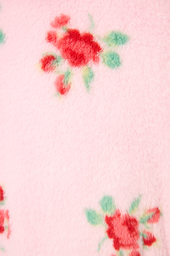 Close-up of the Rose Print Plush Robe by P.J. Salvage, featuring soft pink fleece with red and green rose designs and a cozy, fuzzy texture.