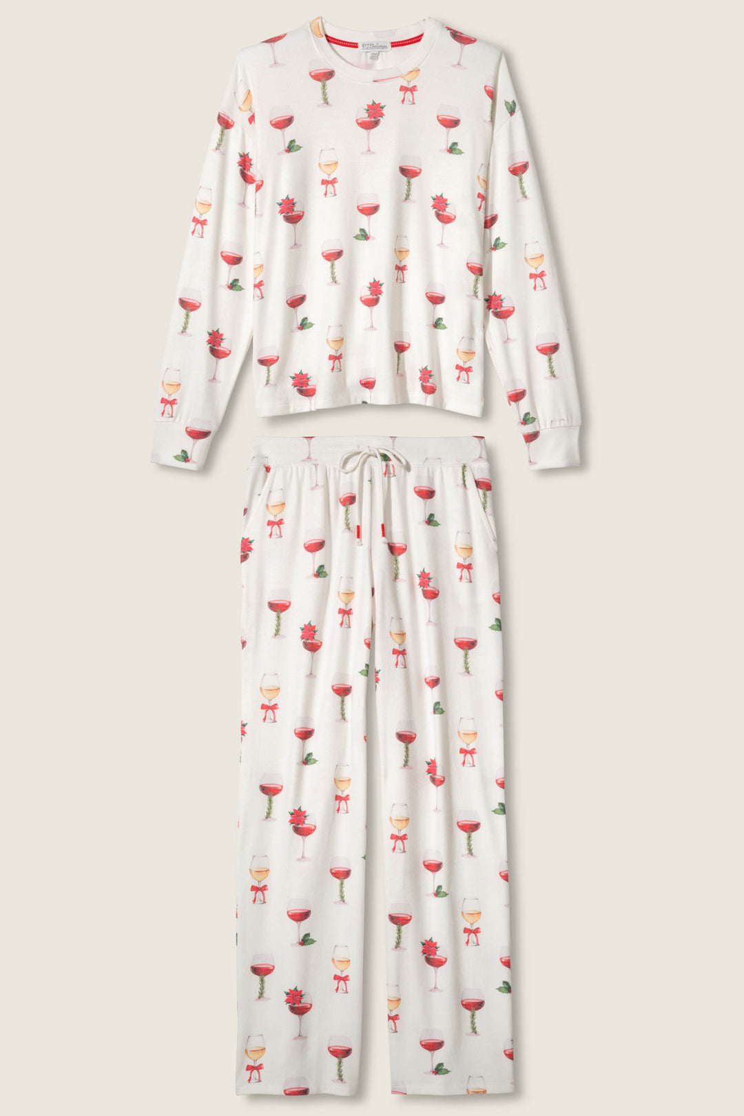 The P.J. Salvage Let's Get Toasty Holiday Wine Print Pants Set is a white pajama set with long sleeves and pants, decorated with red and green holiday drinks, and features a drawstring waist.