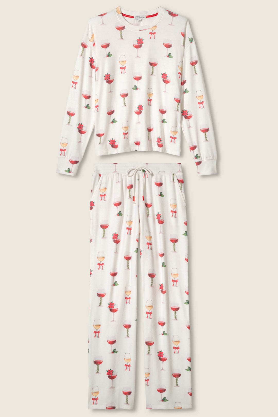 The Let's Get Toasty Holiday Wine Print Plus Size Pants Set by P.J. Salvage features a long-sleeve top and drawstring pants in beige, with a white base and a repeating red wine glass and small red flower print.