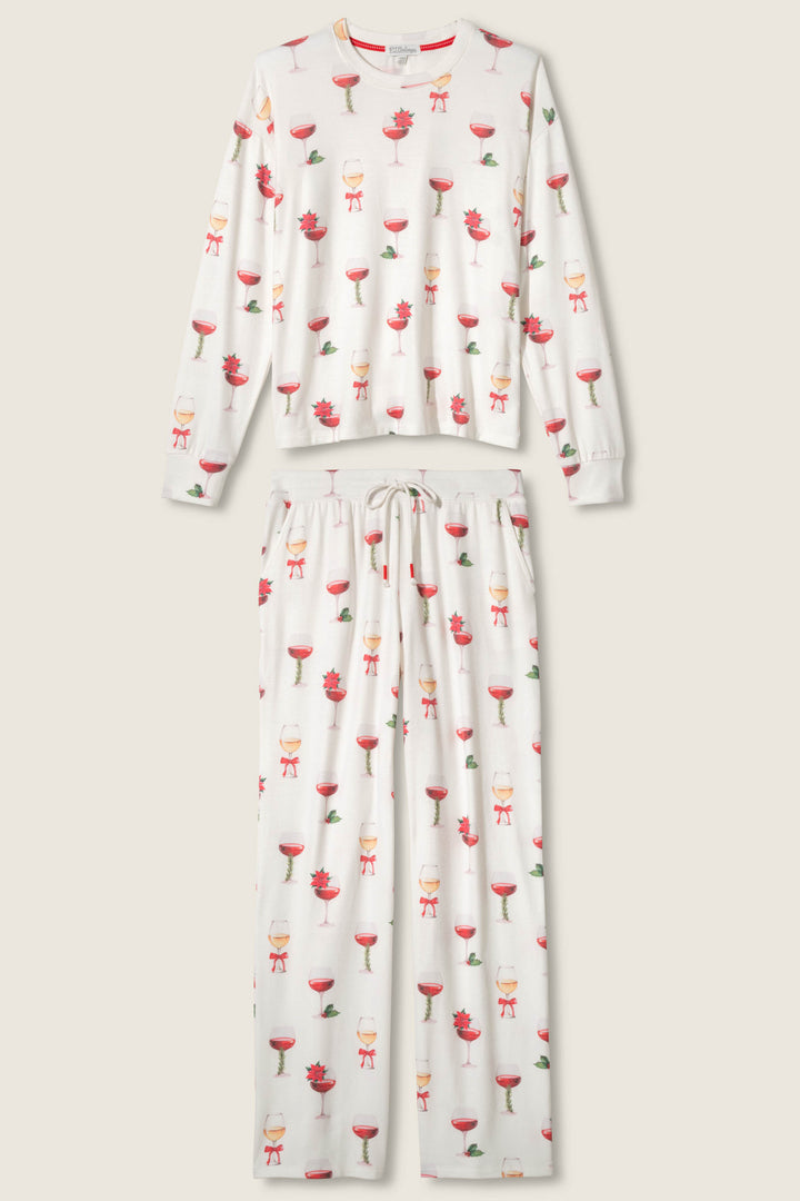 The Let's Get Toasty Holiday Wine Print Plus Size Pants Set by P.J. Salvage features a long-sleeve top and drawstring pants in beige, with a white base and a repeating red wine glass and small red flower print.