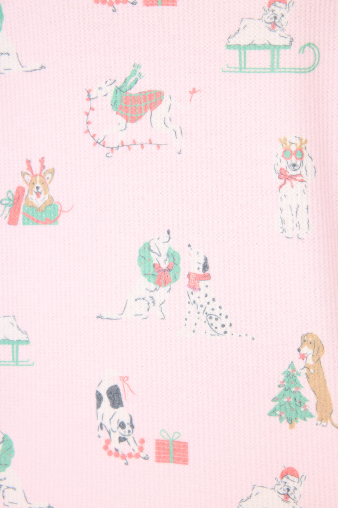 The P.J. Salvage Peace & Pawlidays Dog Print Pants Set features pink fabric decorated with festive dog illustrations, including pups in scarves, with wreaths, sledding, playing with lights, and a Christmas tree with a present.