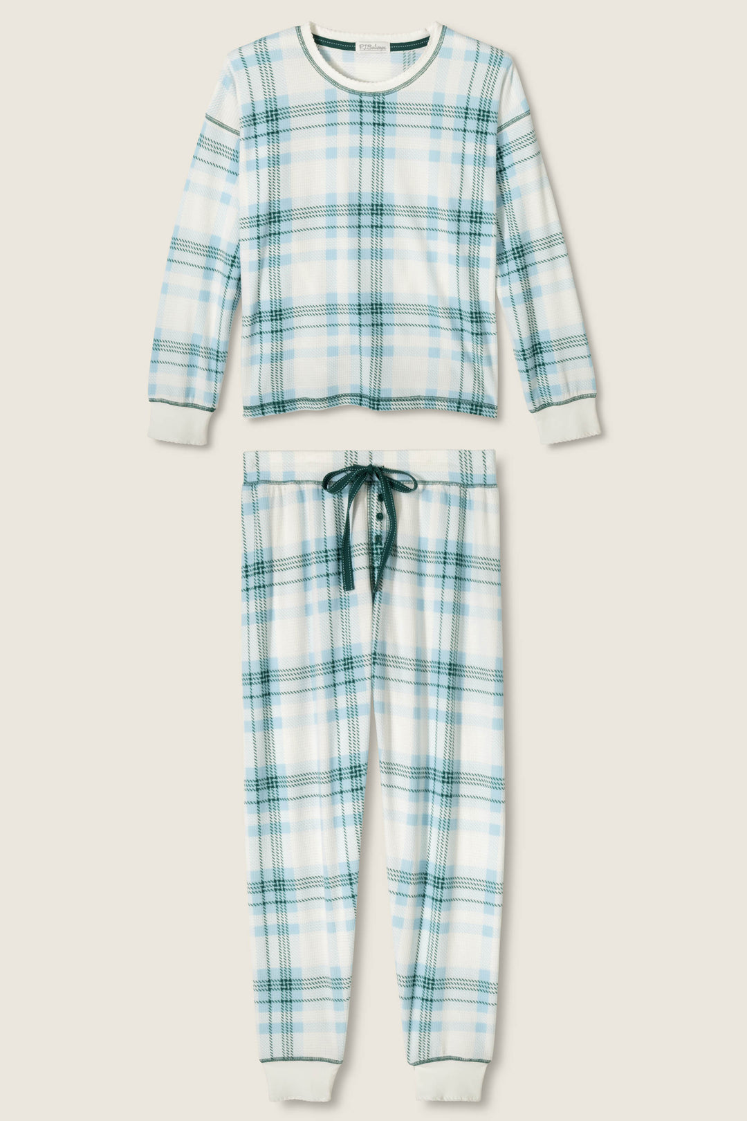 The P.J. Salvage Winter Wonderland Plaid Thermal Velour Pants Set features a blue and green plaid two-piece with a long-sleeve top and drawstring pants, both accented with white ribbed cuffs, shown against a plain light background.