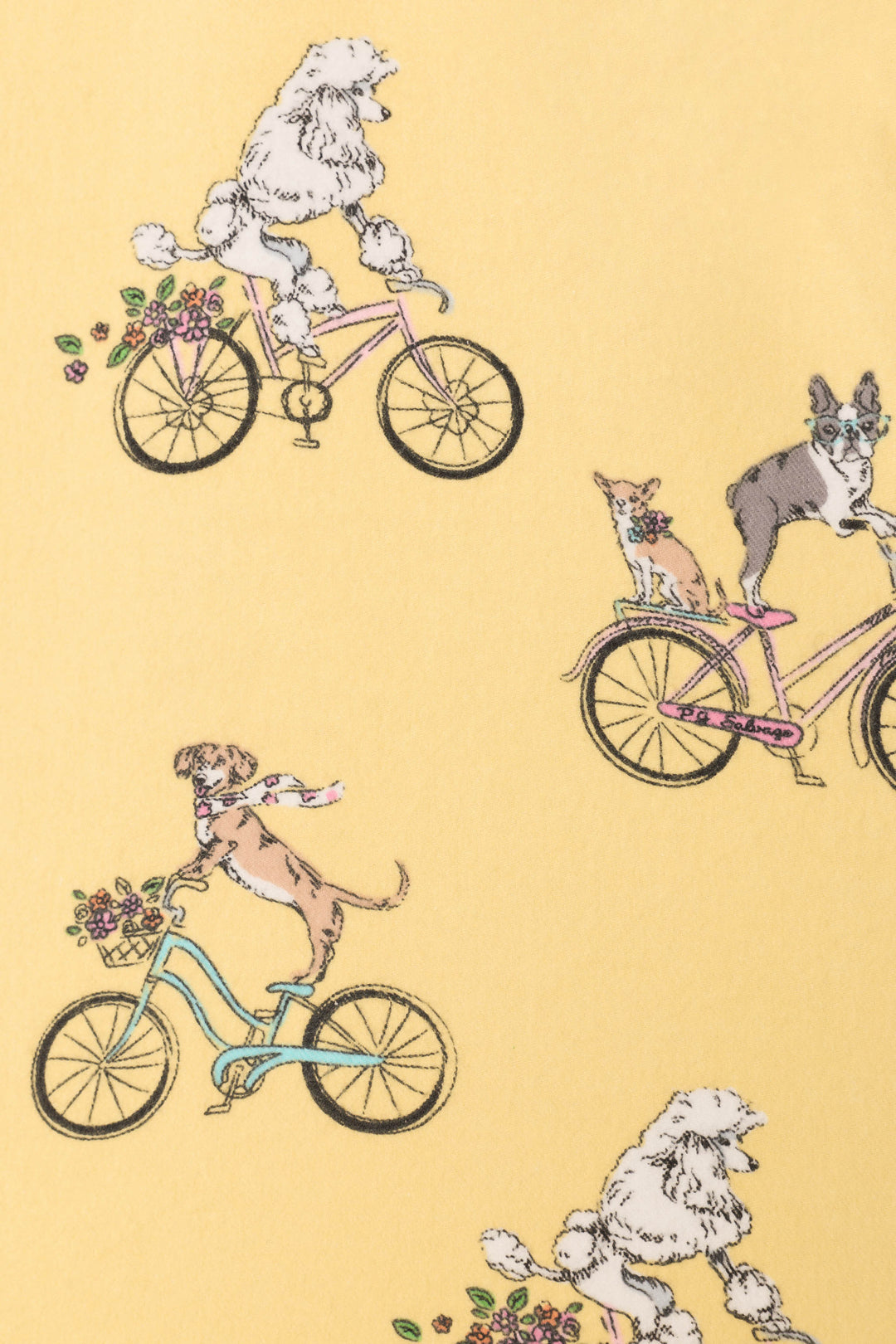 The Let the Good Times Roll 3-Piece Flannel PJ Set by P.J. Salvage features a playful dog bicycle pattern on yellow—poodles, chihuahuas, and florals—for cozy women's sleepwear with whimsical flair.