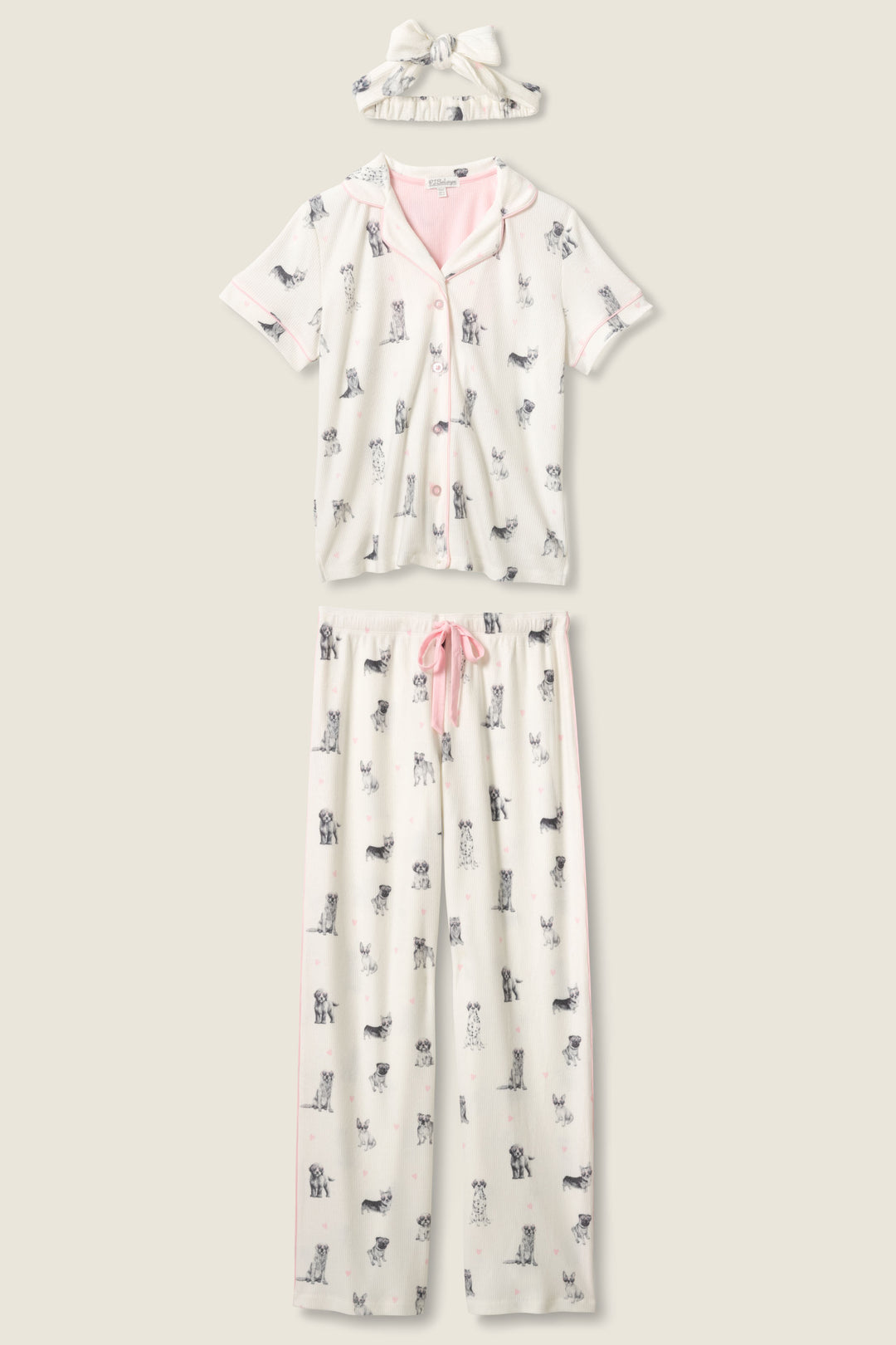 The P.J. Salvage My Dog Is My Valentine 3-Piece PJ Set includes a white short-sleeve button-up top, matching pants with a pink drawstring, and a headband, all featuring small dog prints and light pink accents.