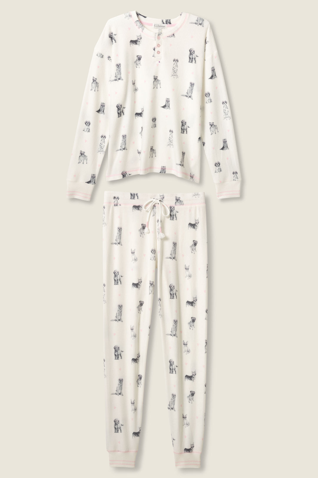 The P.J. Salvage "My Dog Is My Valentine" PJ Set is a cream two-piece with long sleeves, pants, a drawstring waist, and an all-over print of small black and white dog illustrations.