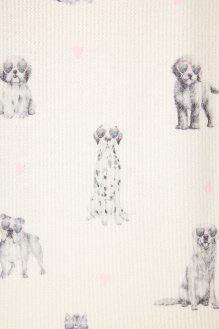 The My Dog Is My Valentine PJ Set by P.J. Salvage features cream-colored fabric with a repeating pattern of illustrated puppies wearing heart-shaped sunglasses and scattered small pink hearts.