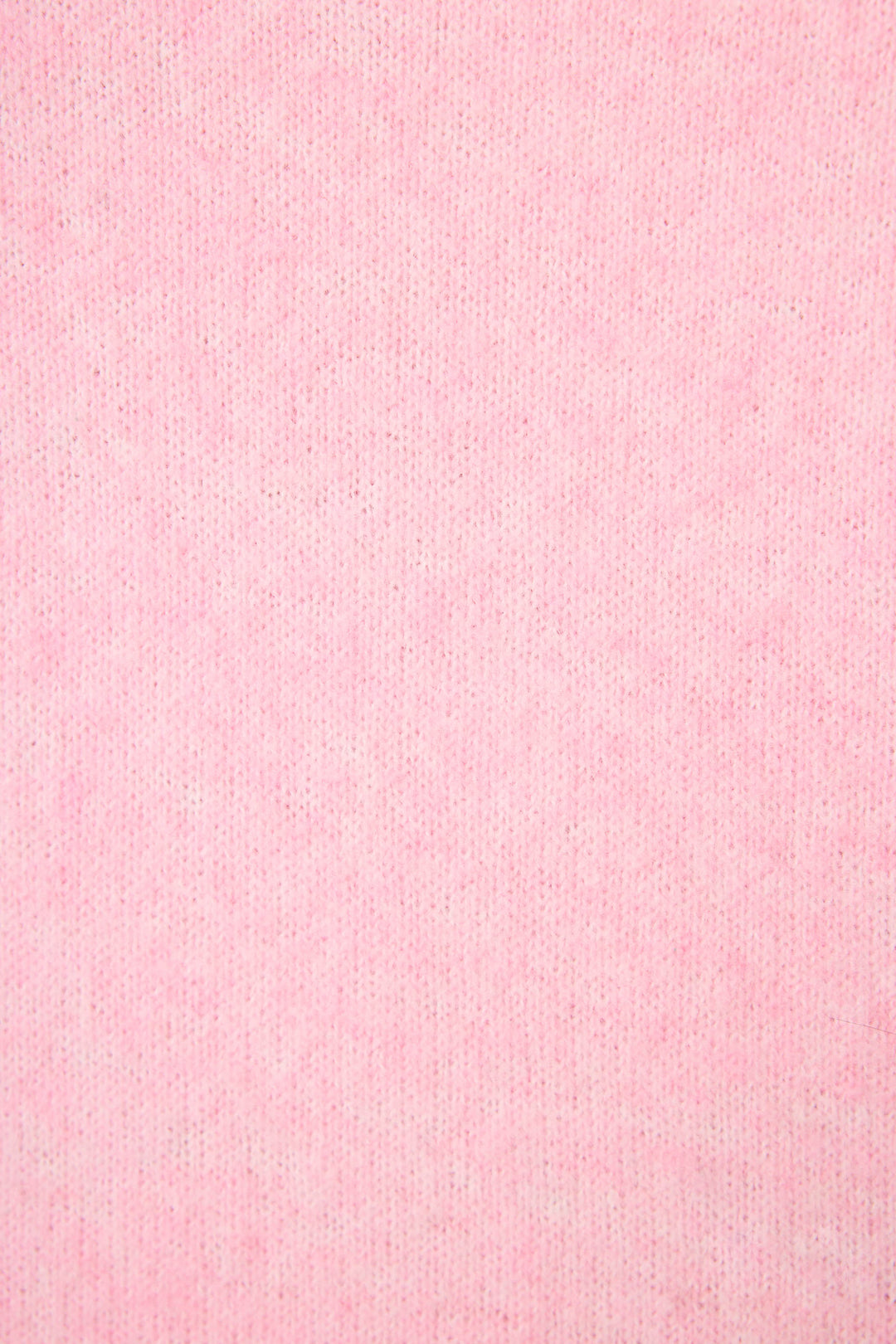 Close-up of P.J. Salvage's Feeling Loved "Lover" Snuggle Sweater, featuring soft, light pink fabric with a subtle, even texture and fine vertical ribbing.