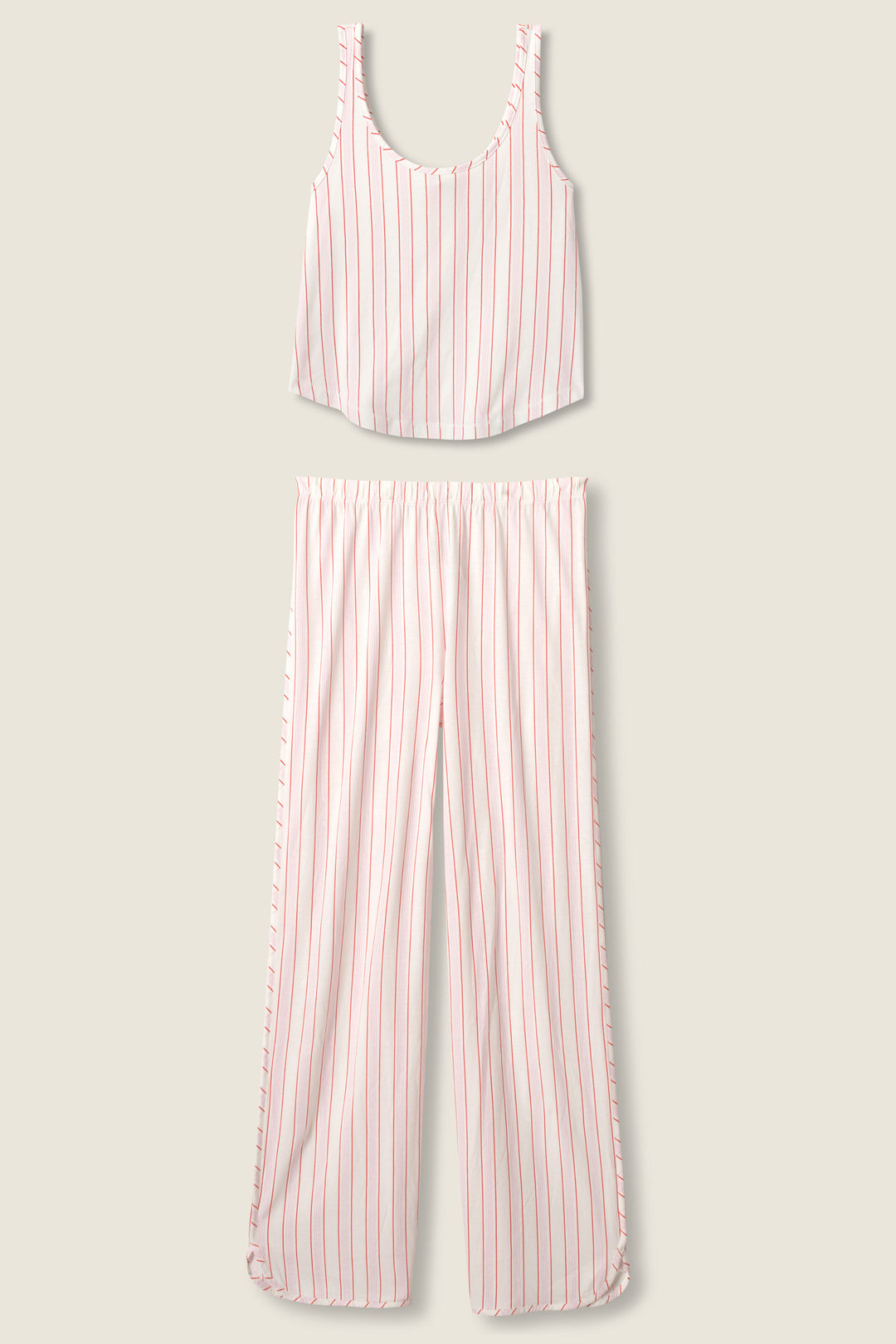 The Feeling Loved Striped PJ Set by P.J. Salvage features a sleeveless scoop-neck crop top and wide-leg pants, both in white with vertical red stripes, displayed flat on a beige background.