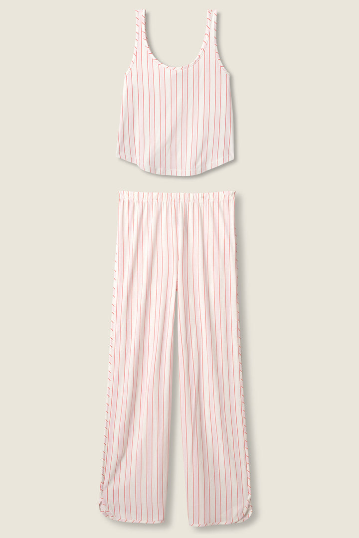 The Feeling Loved Striped PJ Set by P.J. Salvage features a sleeveless scoop-neck crop top and wide-leg pants, both in white with vertical red stripes, displayed flat on a beige background.