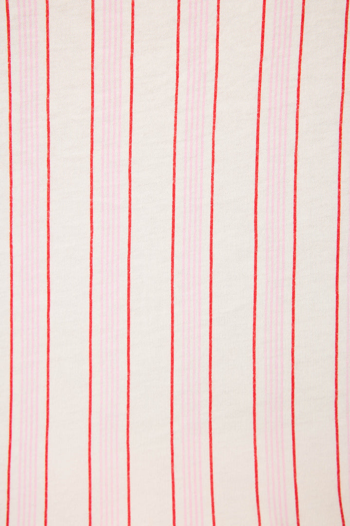 The Feeling Loved Striped PJ Set by P.J. Salvage features white fabric with alternating red and light pink vertical stripes in varying thicknesses for a simple, repetitive look.