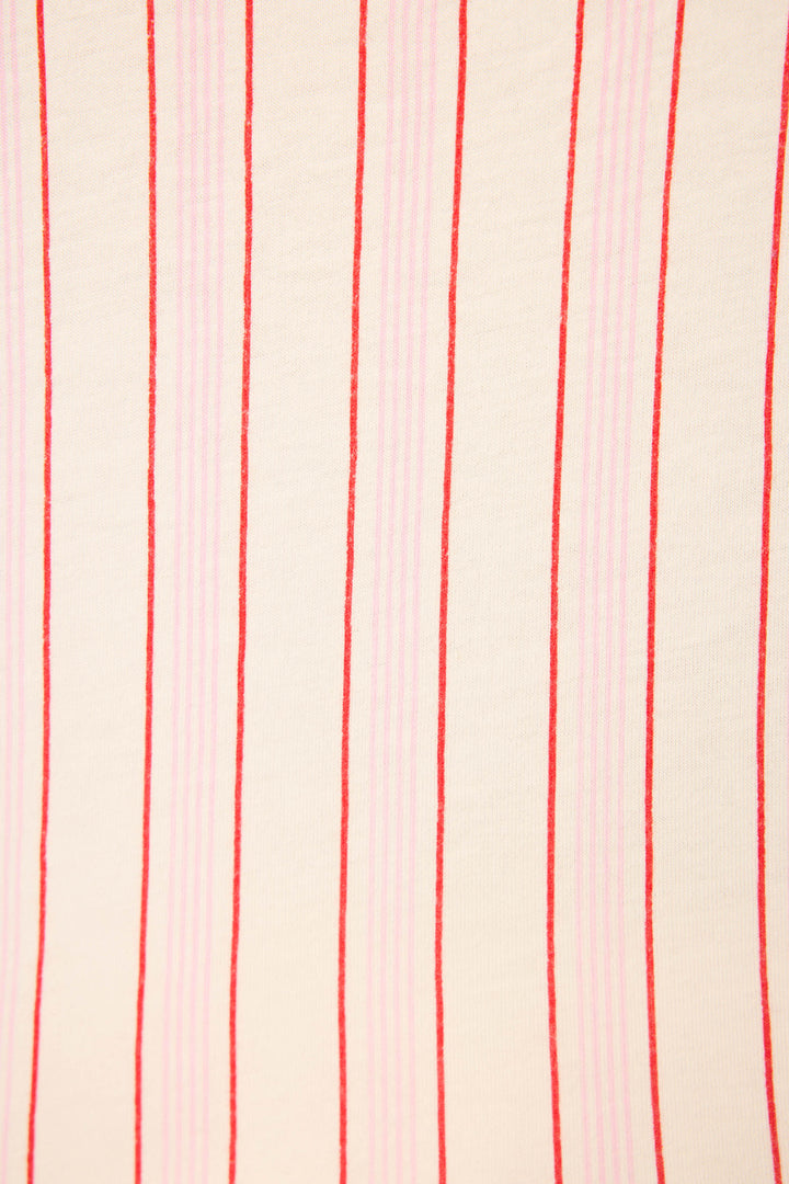 The Feeling Loved Striped Open Leg Pants by P.J. Salvage feature a beige surface with evenly spaced vertical red and pink stripes, reminiscent of cozy pajama pants. The stripes vary in thickness and spacing, running vertically throughout.