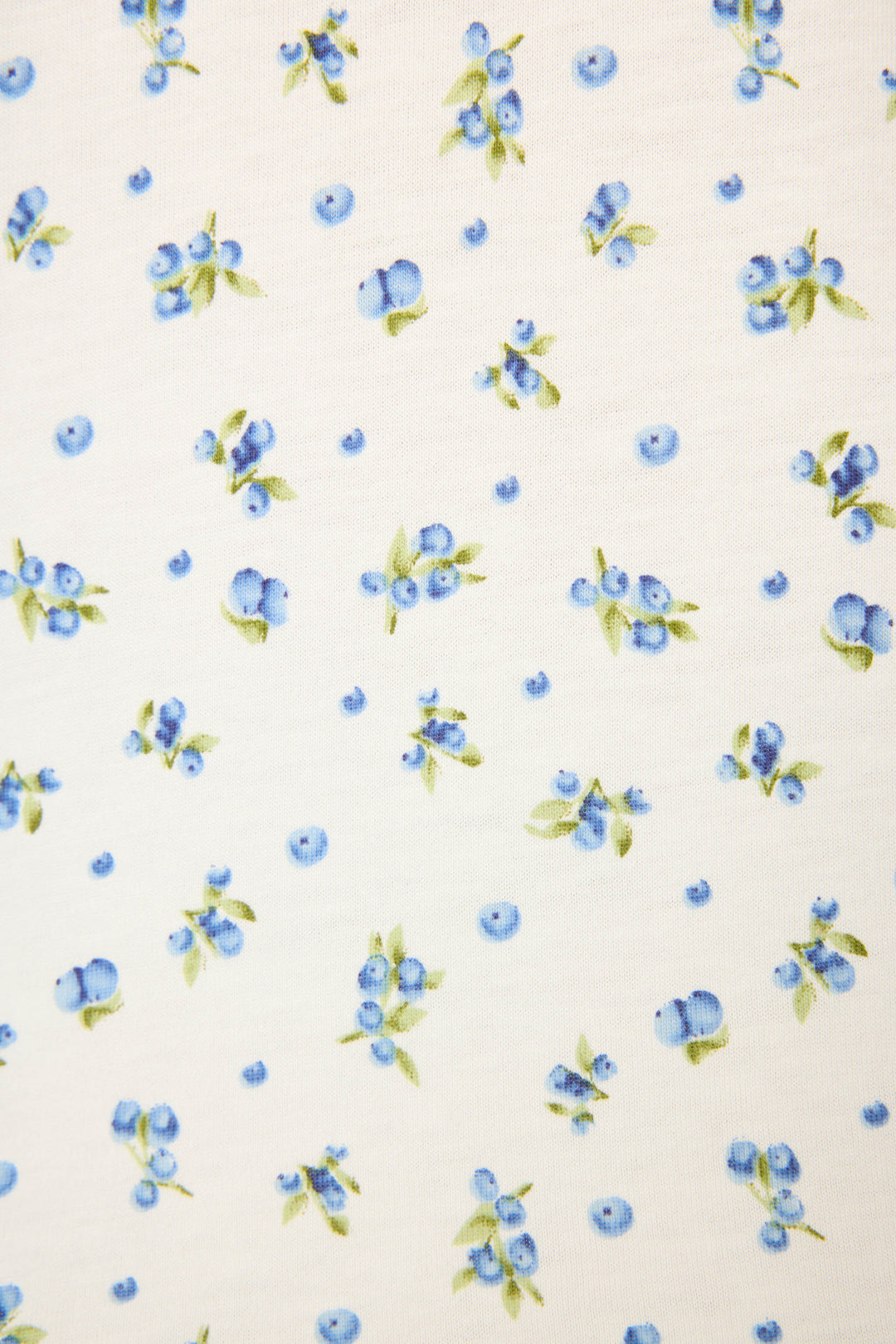 The Mix and Match Blueberry Dreams Sleep Set by P.J. Salvage features a white fabric with evenly spaced clusters of blue and light purple blueberries and green leaves for a fresh, playful look.