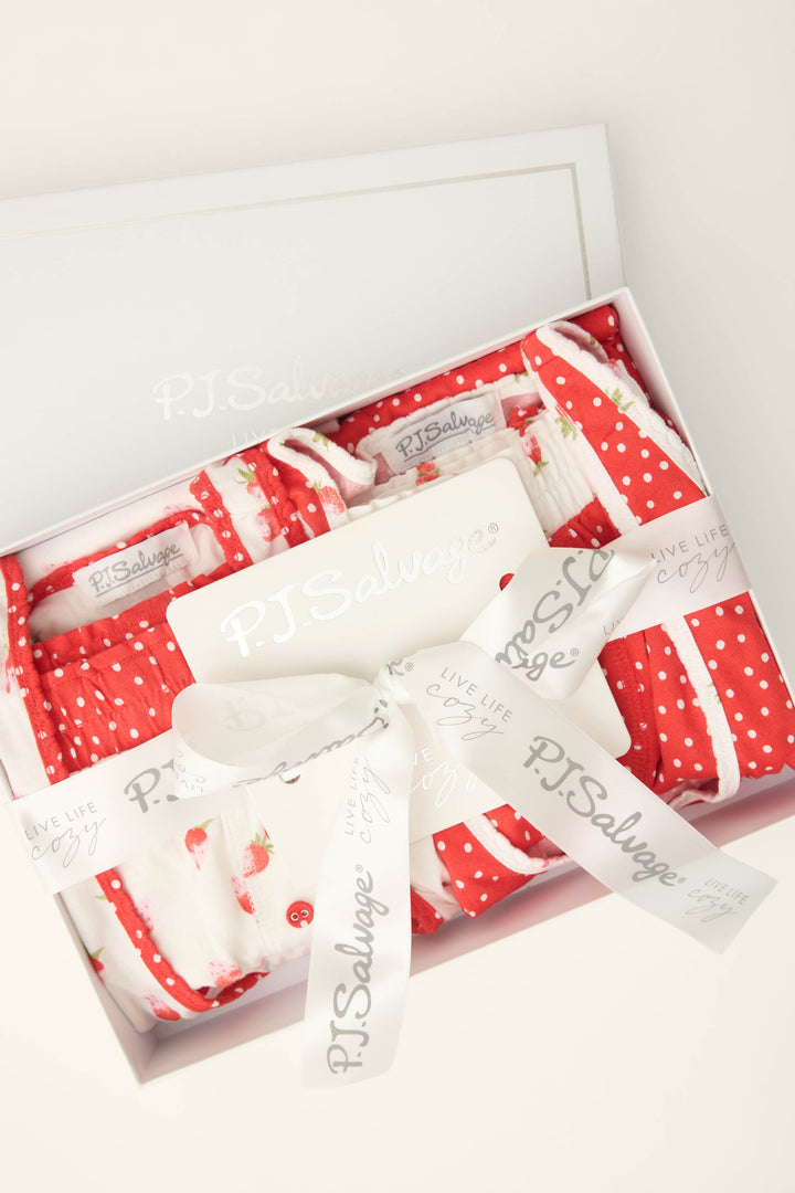 The P.J. Salvage Mix and Match Strawberry Dreams Sleep Set features red and white strawberry and polka dot pajamas, neatly folded with a branded ribbon inside a white box.
