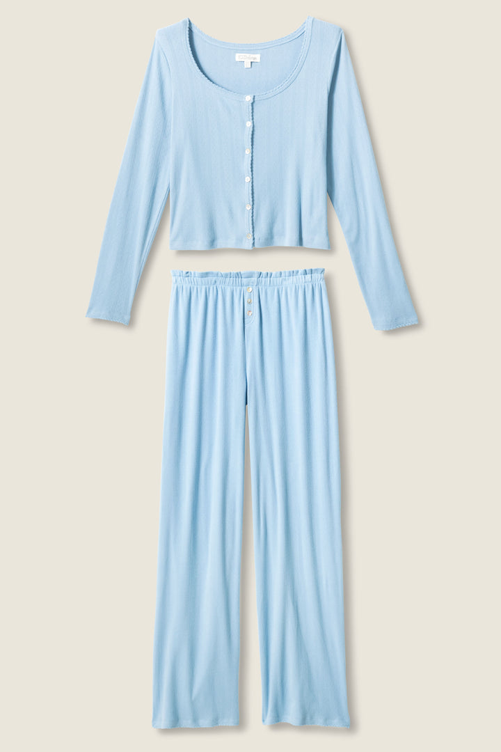 The More Amour Blue Dream Pointelle PJ Set by P.J. Salvage features a light blue, long-sleeve button-up cropped top and matching wide-leg pants with an elastic waistband, displayed on a neutral background.