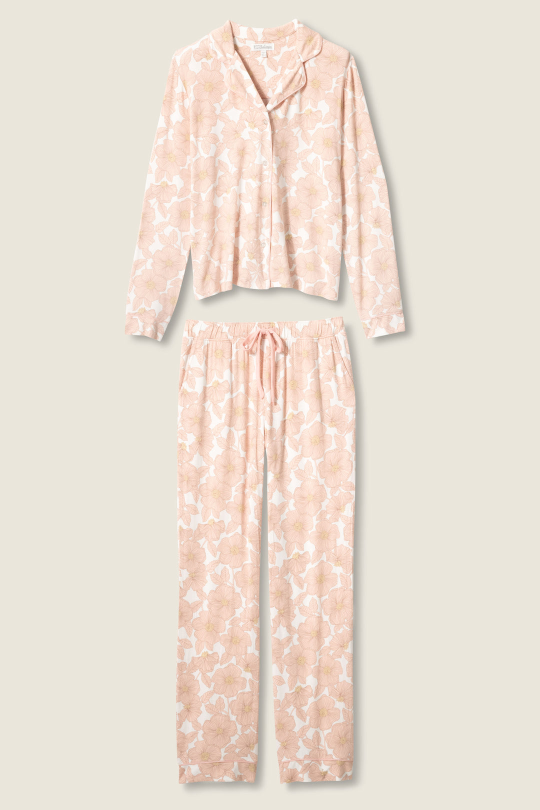 The Poppy Dreams Floral PJ Set by P.J. Salvage features a long-sleeve button-up top and drawstring pants in a light beige and white floral print, shown on a neutral background.