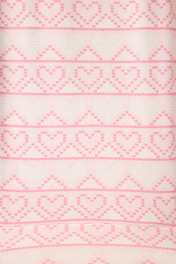 Close-up of the Fairisle Heart Print Peachy PJ Set by P.J. Salvage, showing a light pink and white symmetrical pattern with evenly spaced rows of knitted heart shapes across the soft fabric.
