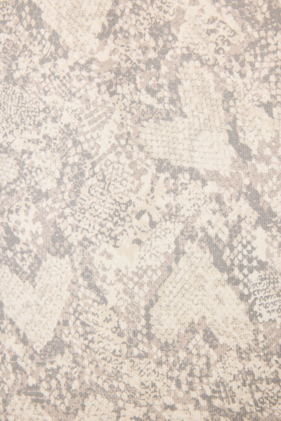 A close-up of the Snakeskin Heart Print Peachy PJ Set by P.J. Salvage, showcasing textured fabric in light beige and gray with a subtle snakeskin pattern and faint heart shapes.