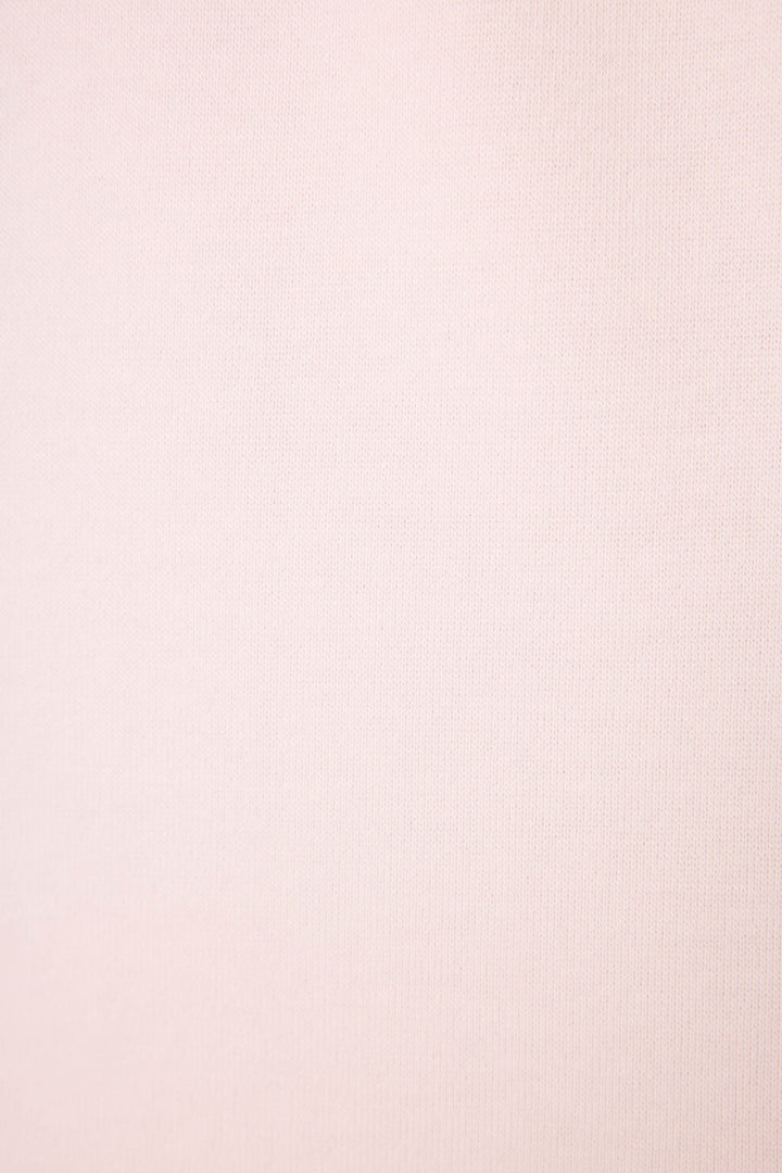 Close-up of the Sweet Life "I'm A Real Treat" Lounge Set by P.J. Salvage, featuring soft light pink fabric with a fine, subtle texture and no visible patterns or designs.