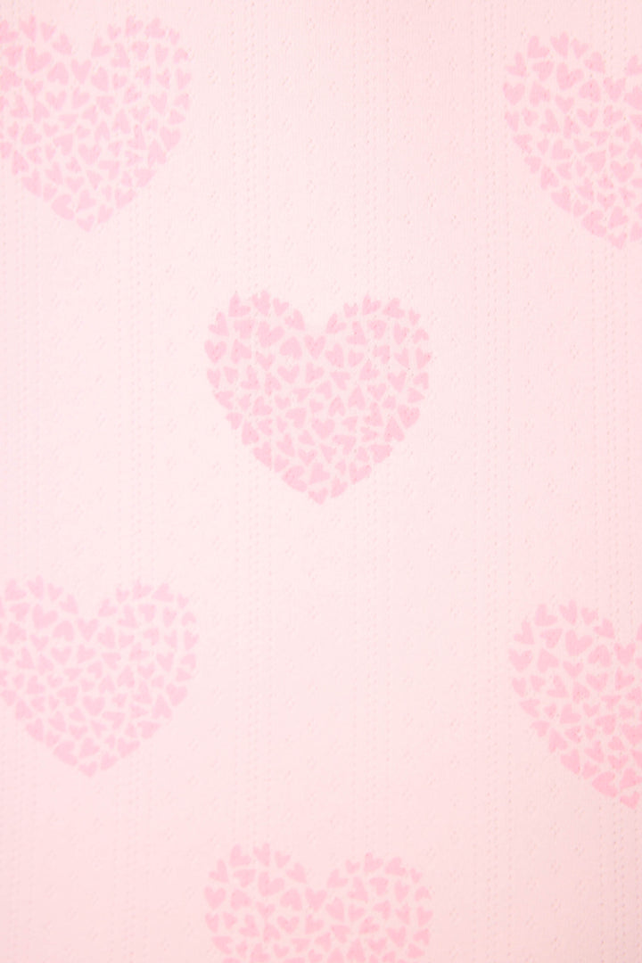 The Valentine's Day Leopard Hearts Print 3-Piece PJ Set by P.J. Salvage features a light pink background with a repeating pattern of large hearts formed by smaller, darker pink leopard-print hearts, creating an evenly spaced, soft, and textured look.