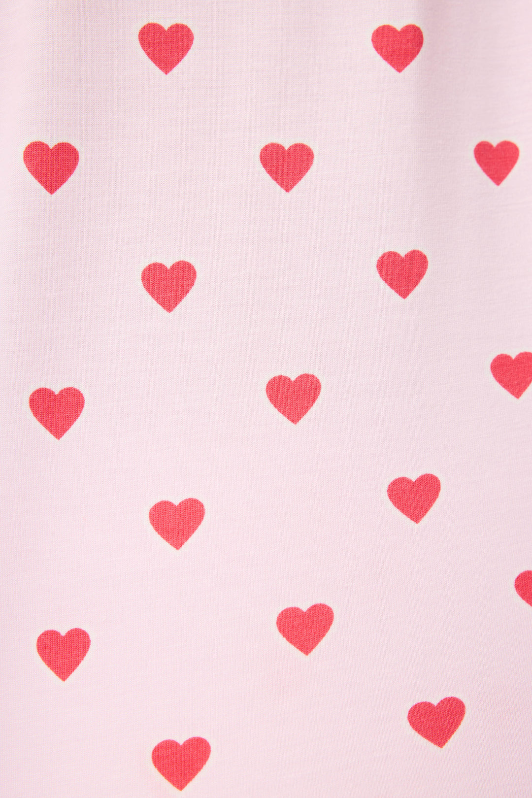 The Wildest Dreams Heart Print 3-Piece PJ Set by P.J. Salvage features a light pink fabric adorned with evenly spaced red hearts arranged in rows.