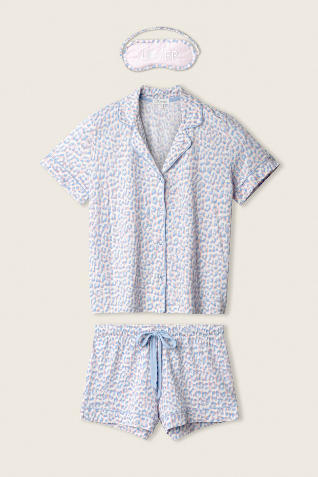 The P.J. Salvage Animal Lover Leopard Print 3-Piece Shorts Set includes a short-sleeve button-up shirt, drawstring shorts, and a sleep mask in light blue and pink animal print on white.