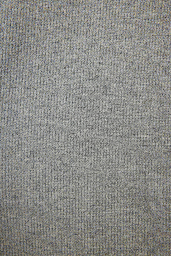 Close-up of the grey, textured fabric from the P.J. Salvage Cross Stitch Casuals Charcoal Lounge Set, featuring a subtle checked pattern and visible weave for a soft, slightly fuzzy look.