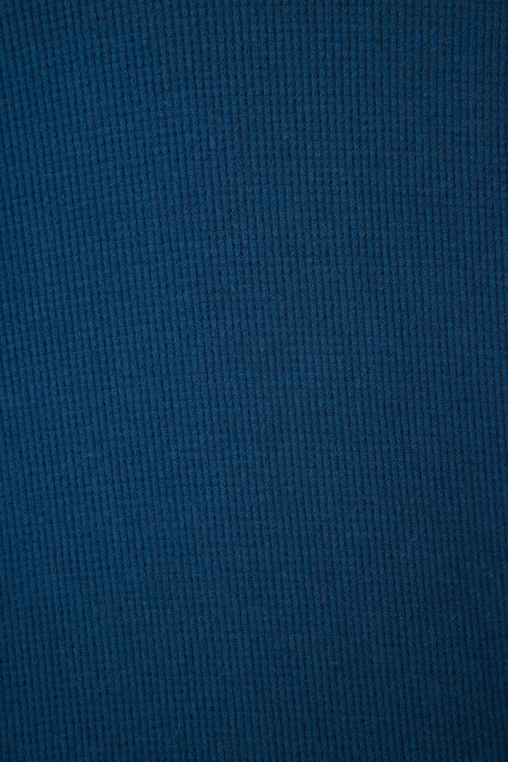 Close-up of the Cross Stitch Casuals Navy Lounge Set by P.J. Salvage, featuring blue ribbed fabric with vertical textured lines, offering a soft feel and uniform color and texture throughout.