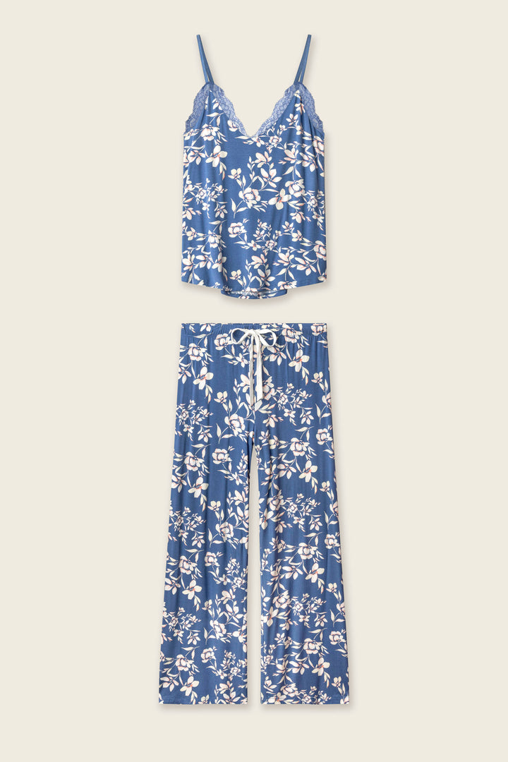 The Flora Dreams Twilight Garden Long PJ Set by P.J. Salvage is crafted from silky modal jersey in a blue floral print, featuring a lace-trim cami top and matching drawstring wide-leg pants, both displayed flat on a light background.