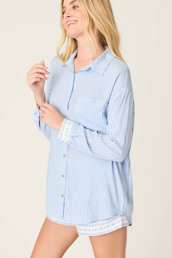 A woman with long blonde hair wears the P.J. Salvage Frutta Fresca Striped Long Sleeve Button Up Top, smiling against a plain background and highlighting this classic, relaxed piece of stylish women's sleepwear.