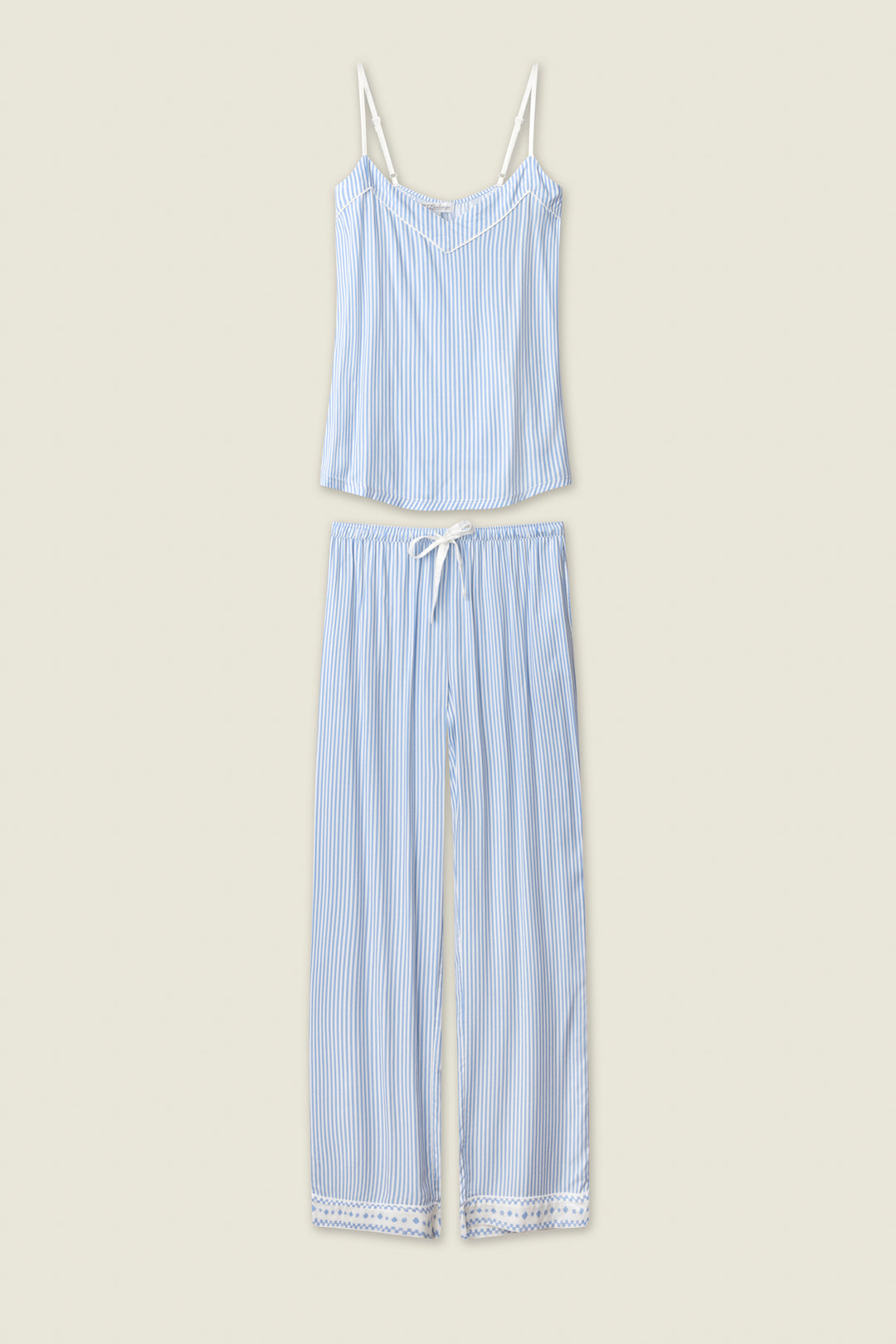 The P.J. Salvage Frutta Fresca Striped Long Lounge Set features thin blue and white stripes, a sleeveless spaghetti strap top, and matching drawstring pants with lace-trimmed hems, shown laid flat on a light beige background.