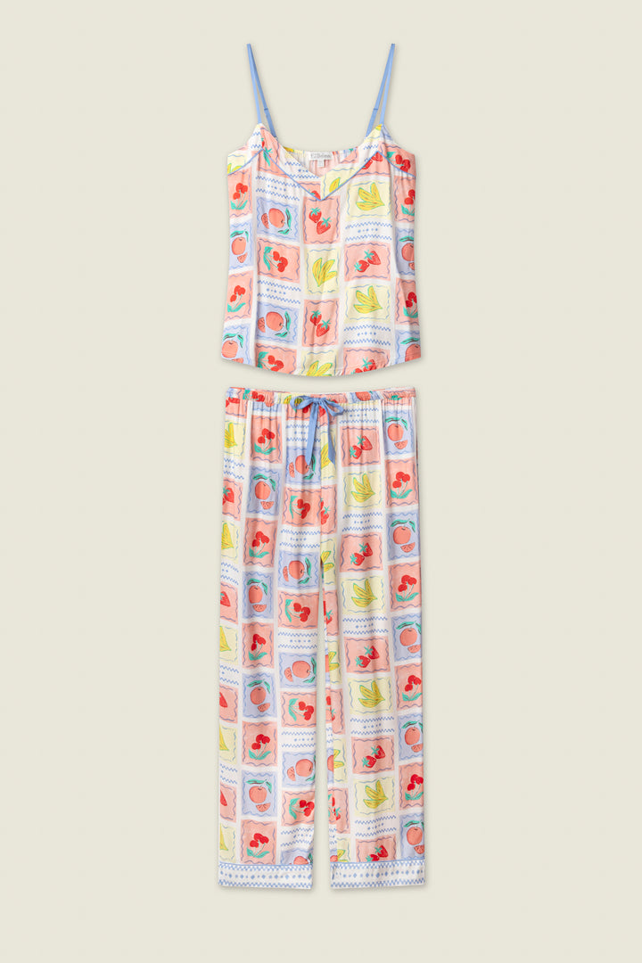 The Frutta Fresca Summer Harvest Long Lounge Set by P.J. Salvage is a silky rayon sateen pajama set with a sleeveless, adjustable-strap top and long pants, adorned with colorful mermaids, seashells, and sea creatures on white.