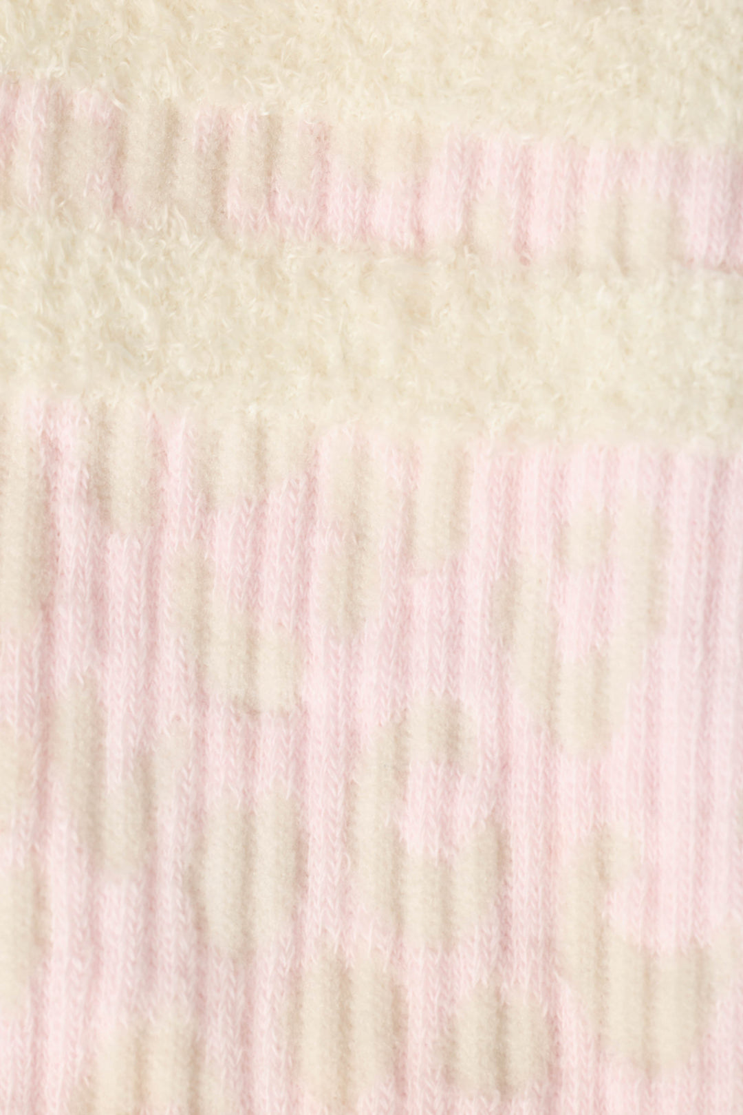 A close-up of Luxe Leopard Dreams Ribbed Crew Socks by P.J. Salvage, featuring soft ribbed fabric with pale pink and off-white stripes and subtle circular patterns.