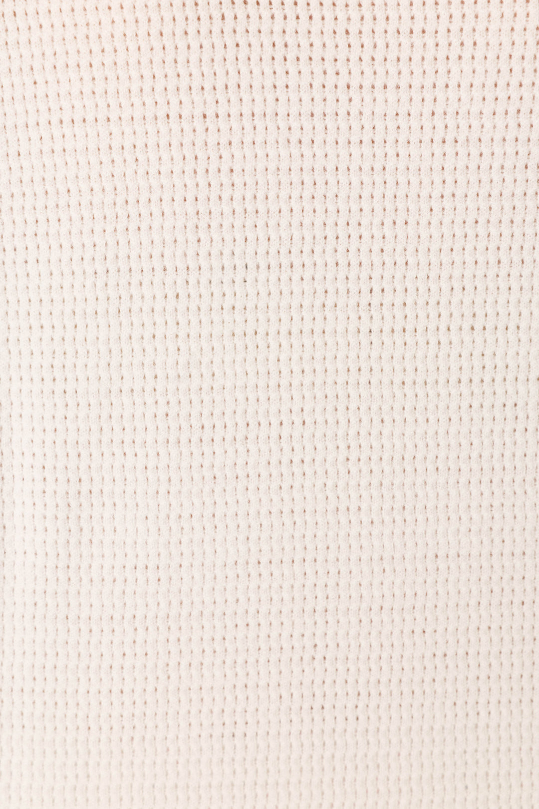 A close-up of the Playful Prints Bon Voyage Pullover Sweater by P.J. Salvage, showcasing its ivory waffle-knit fabric and soft, grid-like textured pattern.