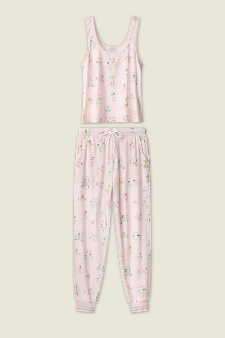 The P.J. Salvage Pupcation Palms Sunnies & Sunshine Long PJ Set is a pink pajama set with a sleeveless tank and drawstring pants, featuring whimsical patterns and playful dog prints on a plain light beige background.