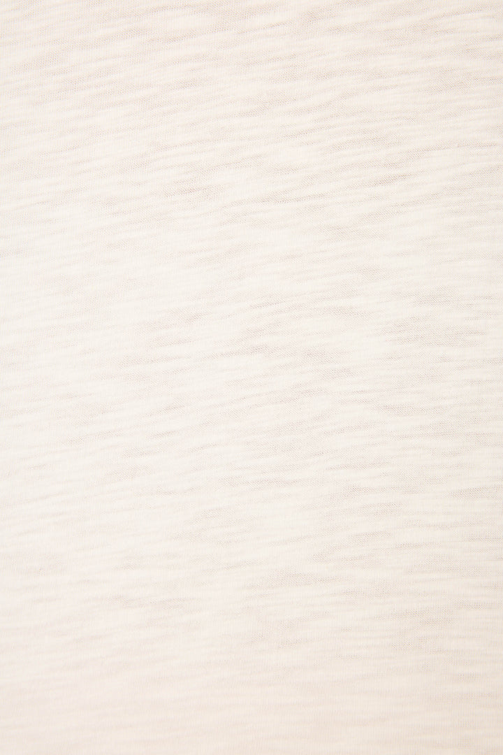 A close-up of the P.J. Salvage Pupcation Palms Dog Mom Graphic Tee reveals its relaxed crewneck design in light beige cotton-modal, featuring subtle horizontal texture and faint lines for a slightly heathered look.