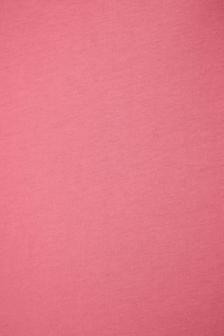 A close-up of the Time to Wine Down Graphic Print Softee Set by P.J. Salvage, highlighting its pink fabric surface with a smooth texture and subtle horizontal weave lines.