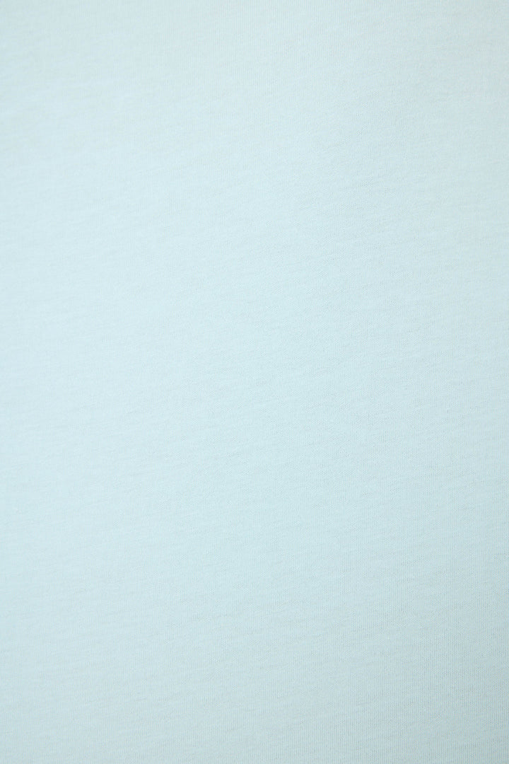 A soft, light gray surface from the Breakfast Club Graphic Print Softee Set by P.J. Salvage, featuring a subtle textured fabric without visible patterns or objects.