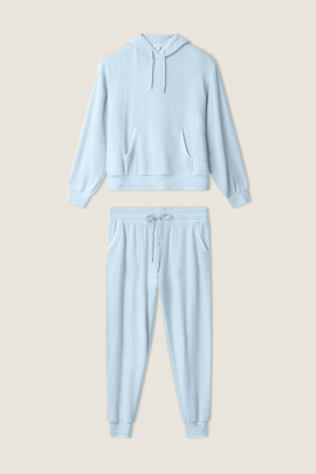 The P.J. Salvage Western Blooms Dream Blue Lounge Set features a hooded sweatshirt with front pockets and long sleeves, plus matching drawstring jogger pants with side pockets, all showcased on a neutral background.