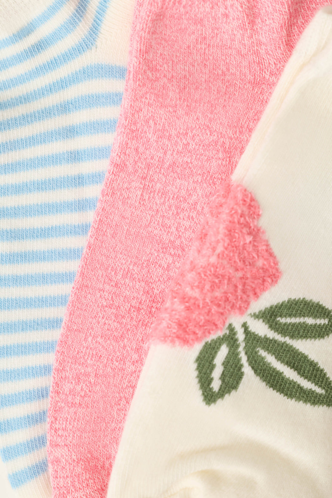 Close-up of the P.J. Salvage Western Blooms Rose Stripe 3-Pack Ankle Socks: blue and white stripes, solid pink, and a cream floral sock with pink rose and green leaves.