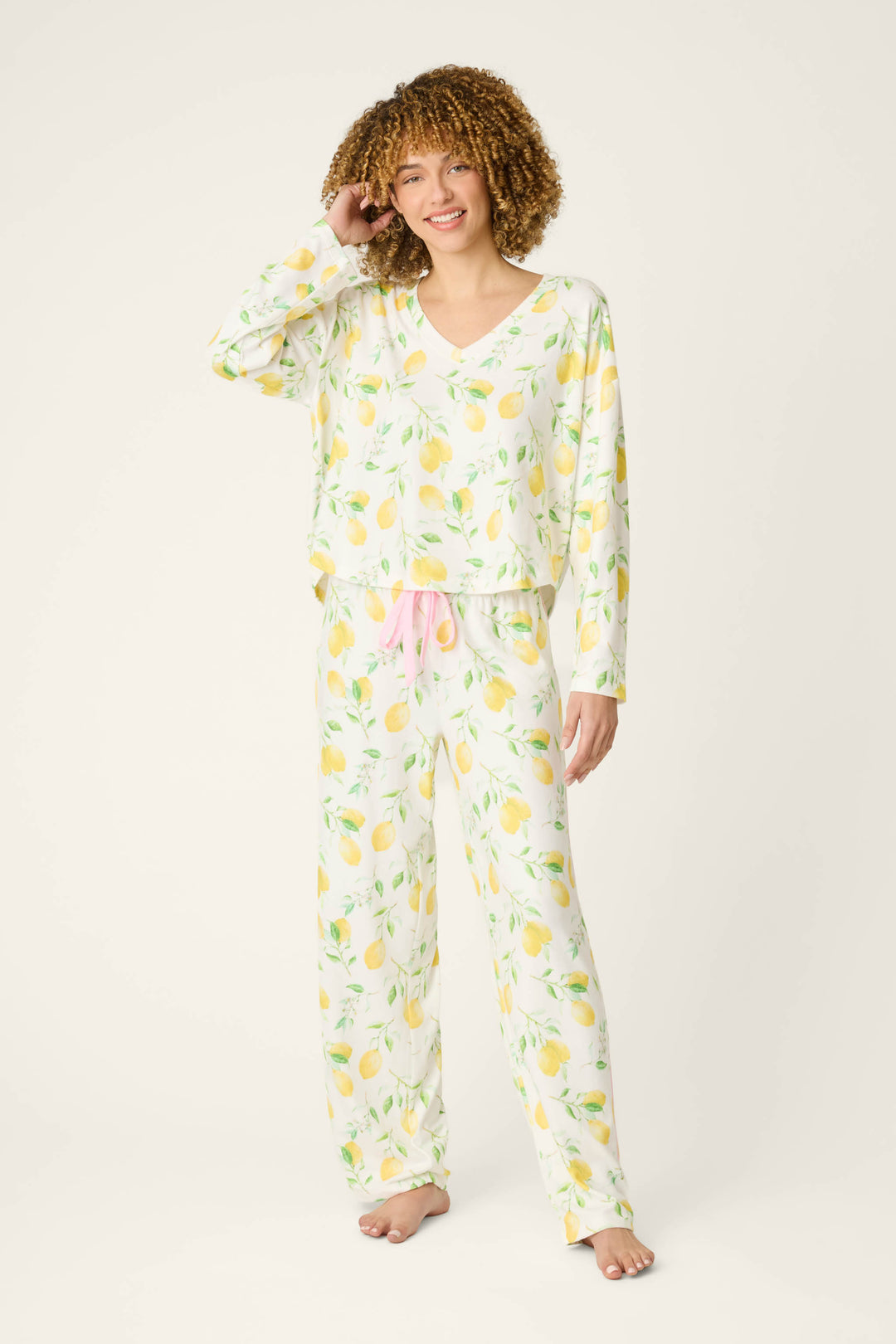 Fabric features a vibrant lemon print on a light background with accents of pink, including a textured pink drawstring detail.