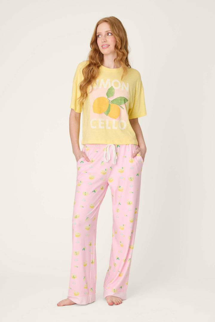 Pattern of small lemons on light fabric with a smooth texture; vibrant yellow t-shirt fabric features a bold lemon graphic.