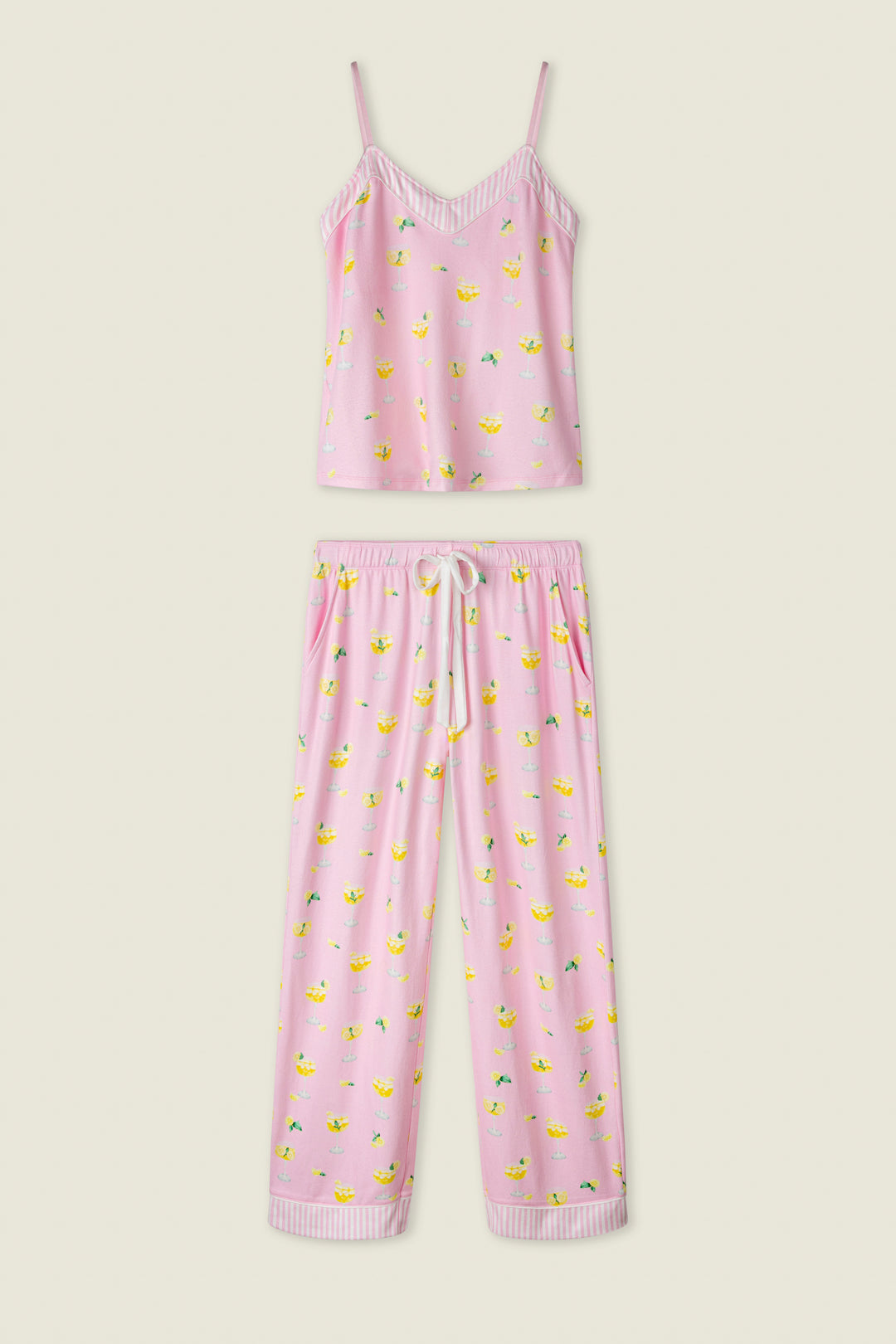 Pink fabric with a playful fruit print and white stripe trim, shown flat against a cream background.