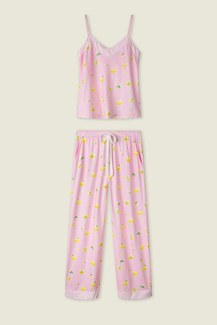 Pink fabric with a playful fruit print and white stripe trim, shown flat against a cream background.